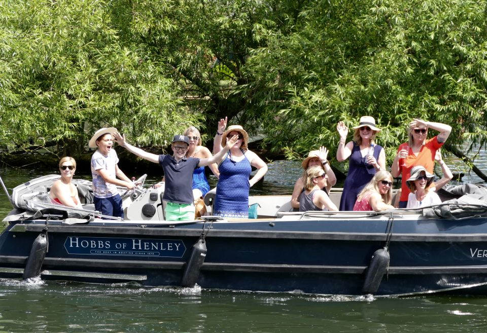 People enjoy a glorious sunny afternoon along the banks of The River Thames in Henley Oxfordshire