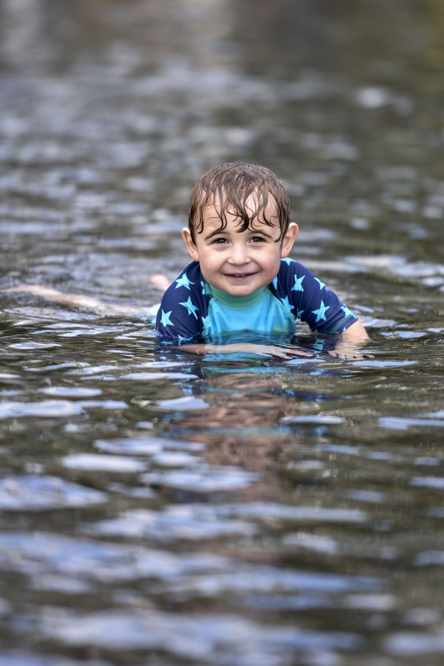 Xan swims in the fountain at City Park, Bradford