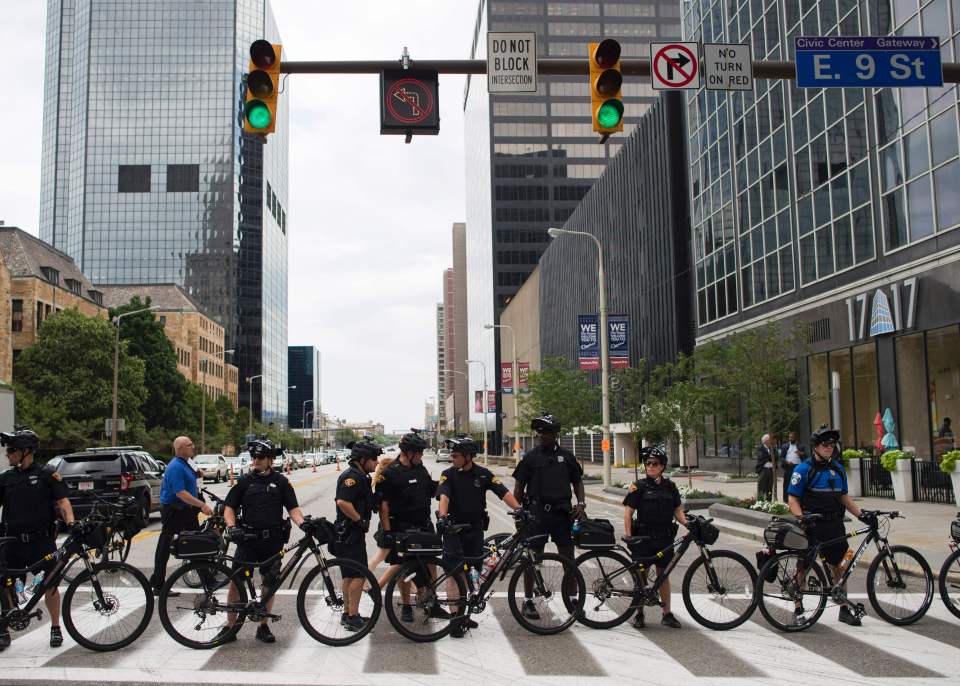 Bike police block a road to redirect ant