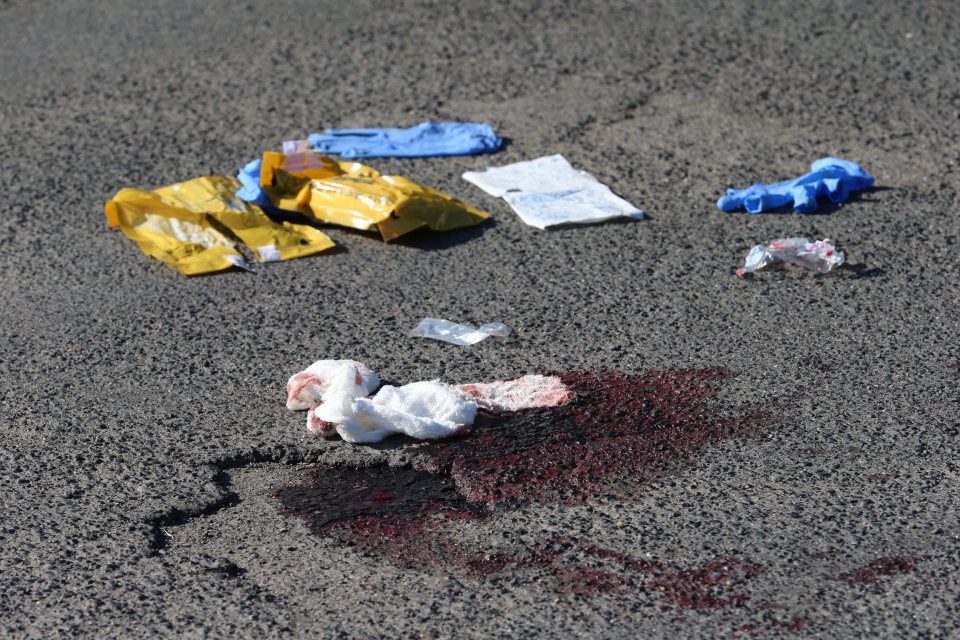 Bloodied possessions were left lying in the street after the horror attack that left four severely injured