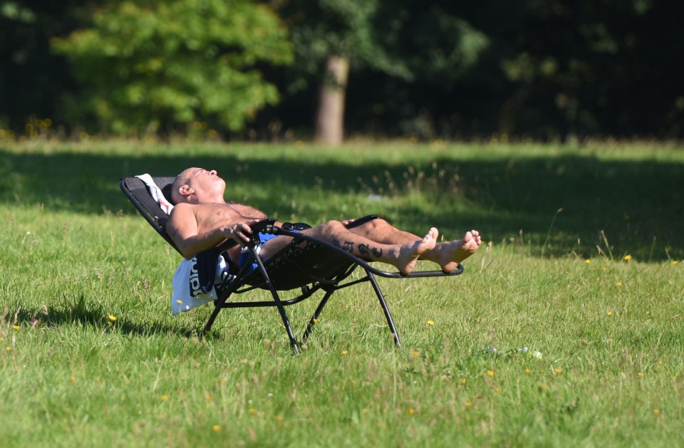 Meanwhile a man soaks up some rays in Sefton Park, Liverpool