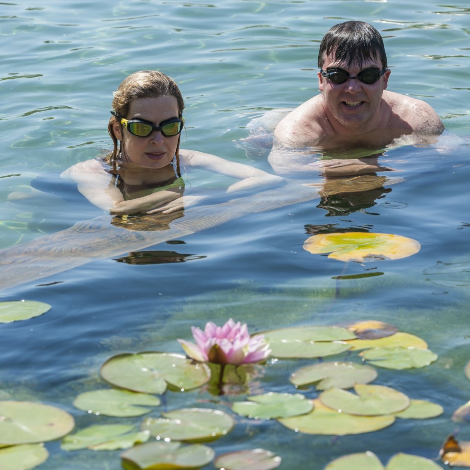 Office workers on their lunch break, Evelyn and Sean, enjoy the cooling waters of King's Cross pond
