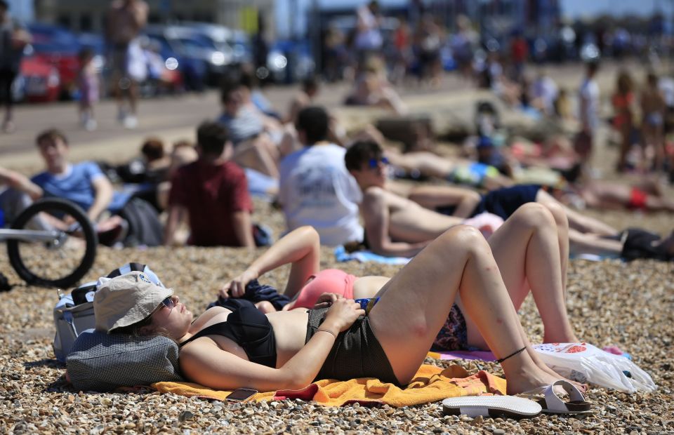 Sunbathers lie on the beach near Southsea Common in Portsmouth, as Britain has sweltered on the hottest day of the year 