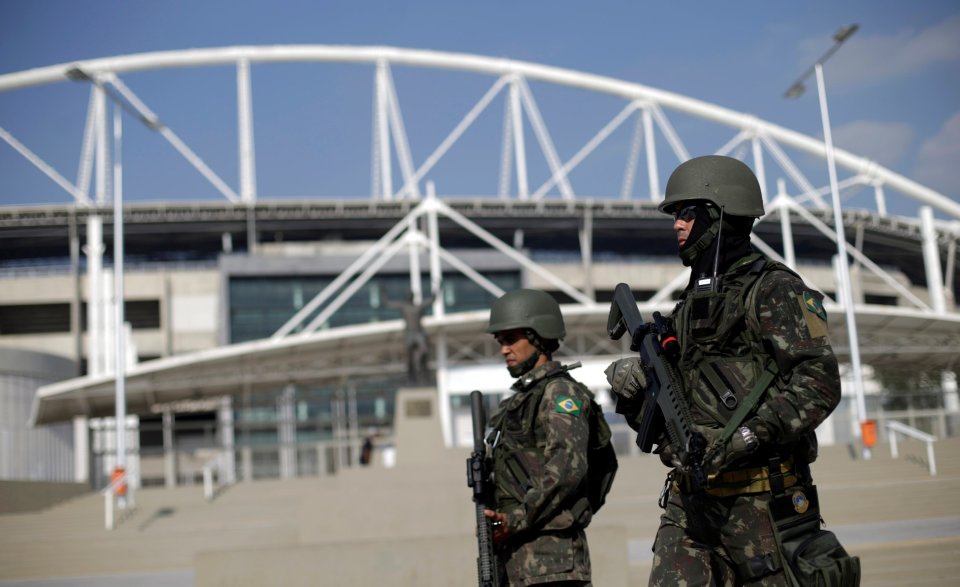 Brazilian Army soldiers patrol in front of the Olympic stadium ahead of the 2016 Rio Olympics in Rio de Janeiro