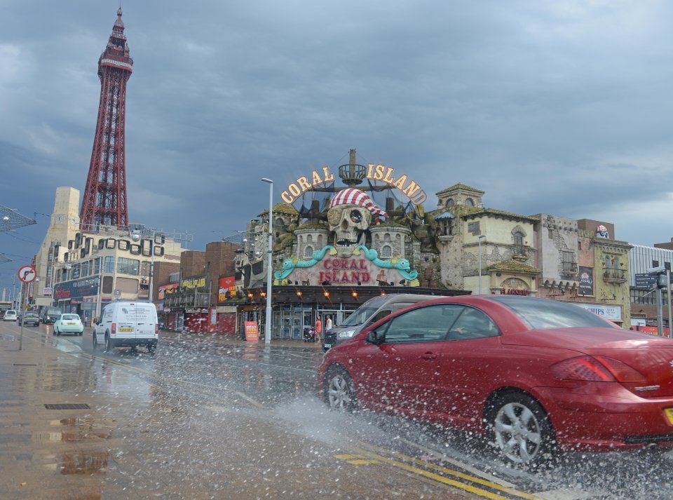 Motorists struggle through heavy rainfall in Blackpool, Lancashire this morning as storms batter the north of the UK and Scotland