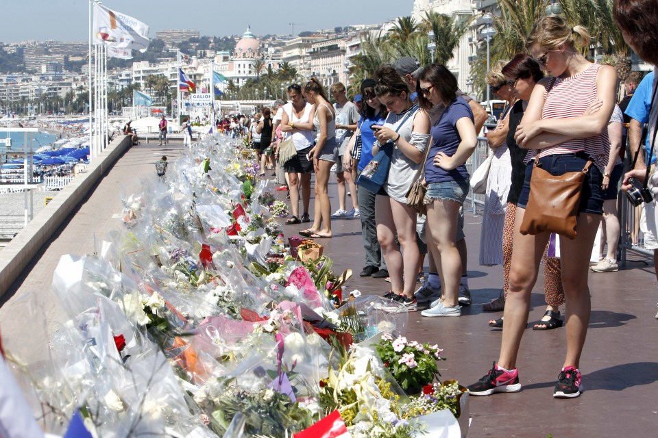 Mourners line the streets laying flowers in tribute to the innocent victims of the vile attack 