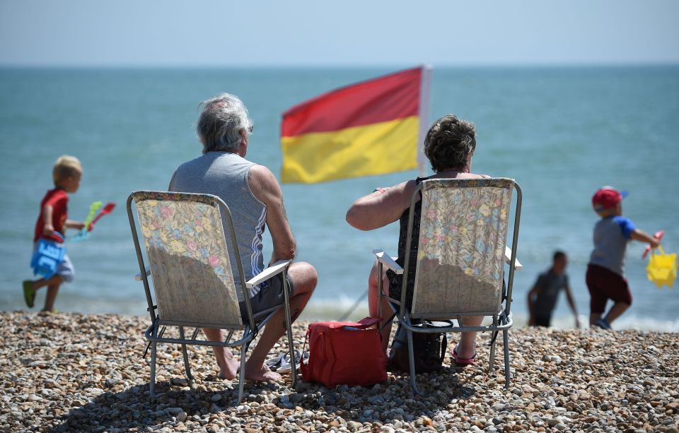 While others enjoy the hot weather on the East beach in Bognor Regis, West Sussex, as heavy thunder showers have hit parts of the UK
