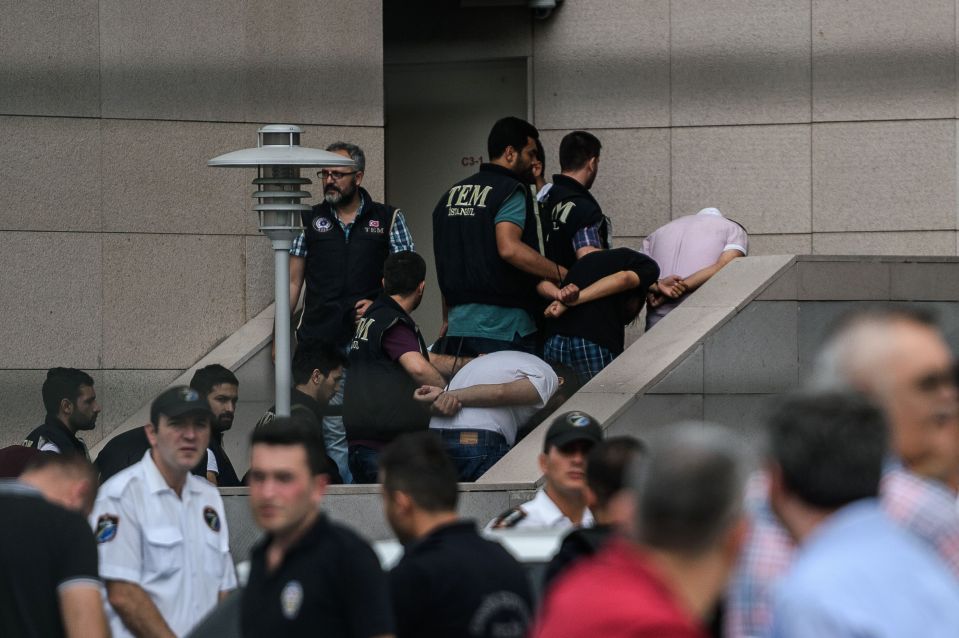 Detained Turkish soldiers who allegedly took part in a military coup arrive with their hands bound behind their backs at the Istanbul Justice Palace