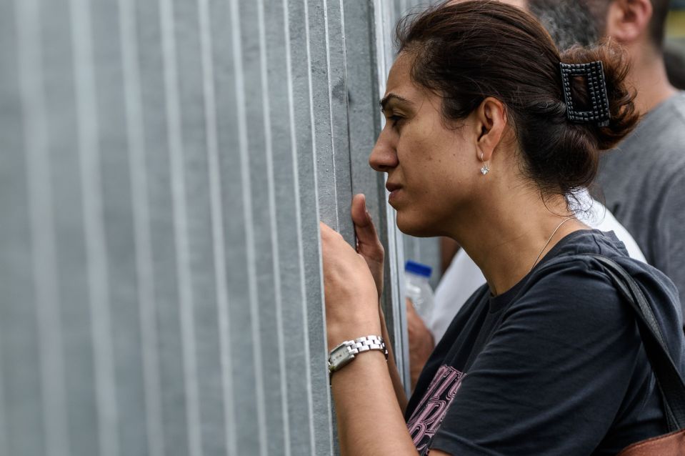 Family members of detained Turkish soldiers wait in front of the Istanbul Justice Palace