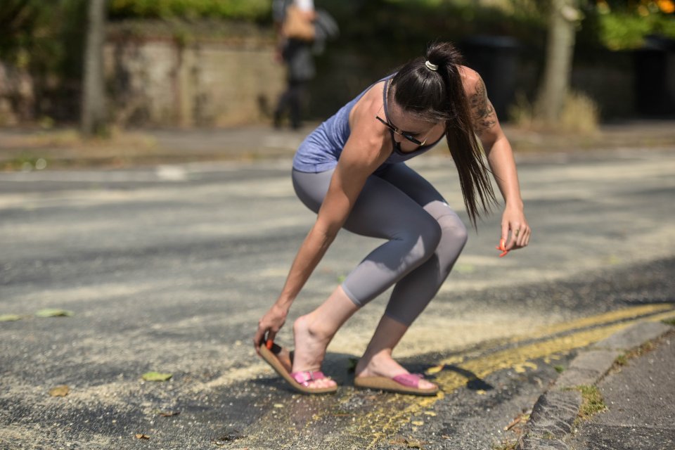 Ellie-may Flack's, 22, sandals stick to the road as she crosses Warwick Road in the Hertfordshire town