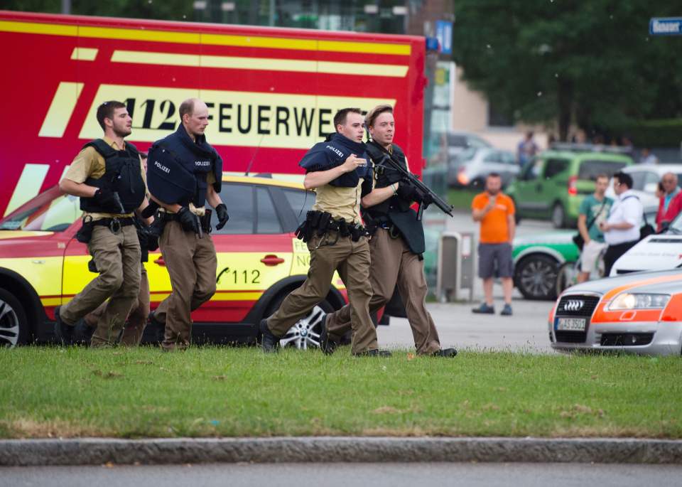 Police running near the shopping mall amid a shooting in Munich today