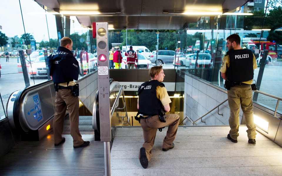 Police secure the entrance to a subway station near a shopping mall where multiple gunmen are believed to have gone on a shooting spree