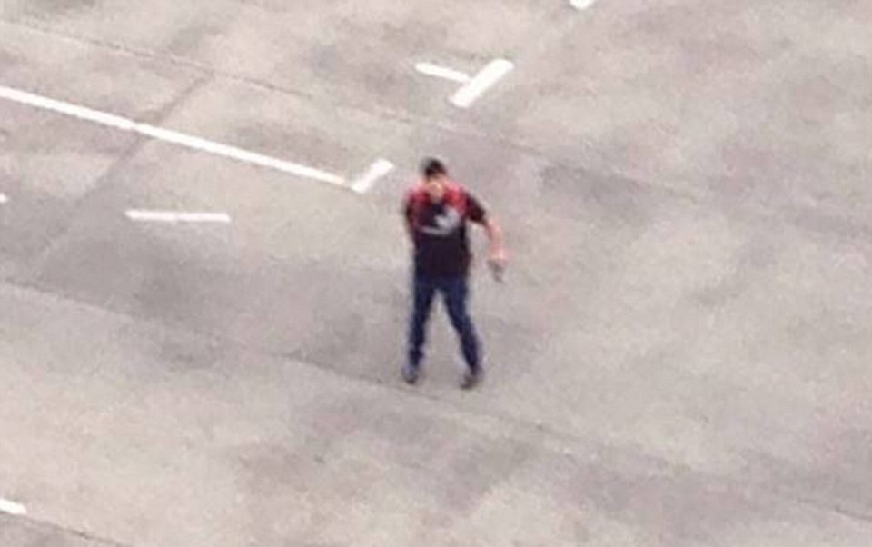 A picture apparently showing the shooter in a car park brandishing a hand gun