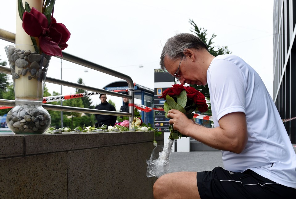 German citizen Thomas Tirolf knees as he