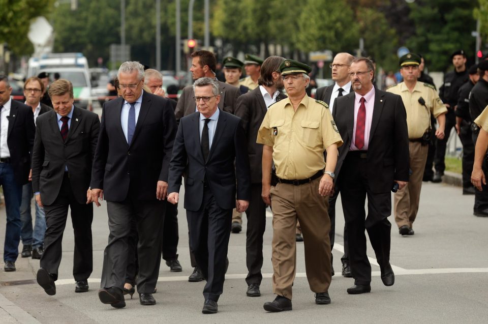 German interior minister Thomas de Maiziere and Bavarion Interior minister Joachim Herrmann attend the crime scene at OEZ shopping center the day after 
