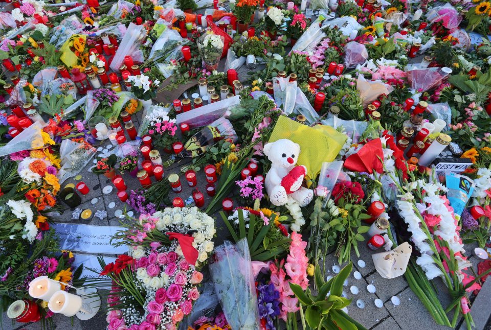 Flowers, toys, candles and cards have been left in memory of those who were killed