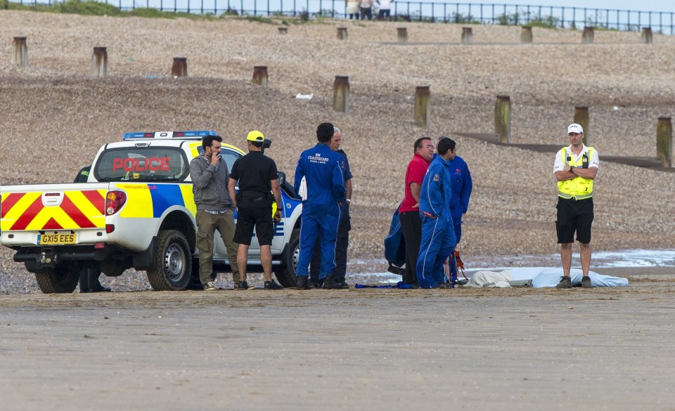 Police were seen carrying a portable body bag on the beach