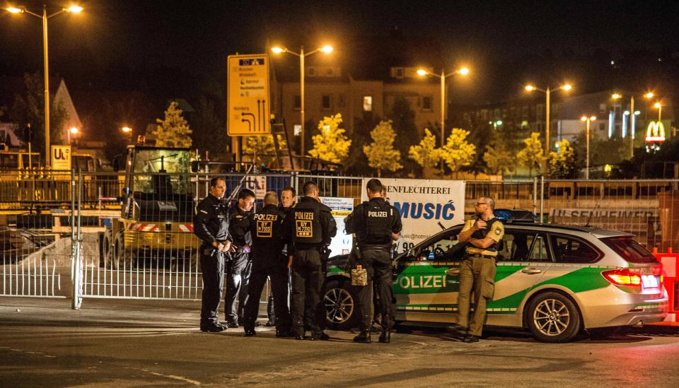 Ansbach, Germany. 25th July, 2016. Members of the German police secure the area surrounding the crime scene after a bomb attack in Ansbach, Germany. Twelve people were injured in an attack that may have had an Islamist background. The attacker was a
