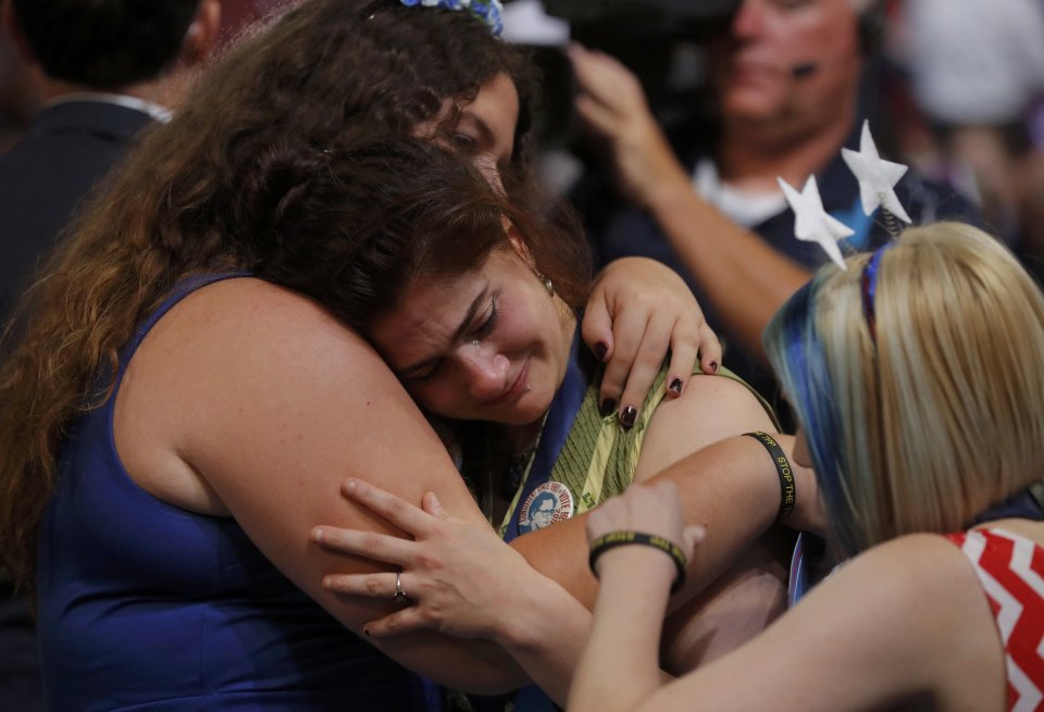 Supporters of former Democratic U.S. presidential candidate Sanders hug and cry at the end of Sanders' speech during the first session at the Democratic National Convention in Philadelphia