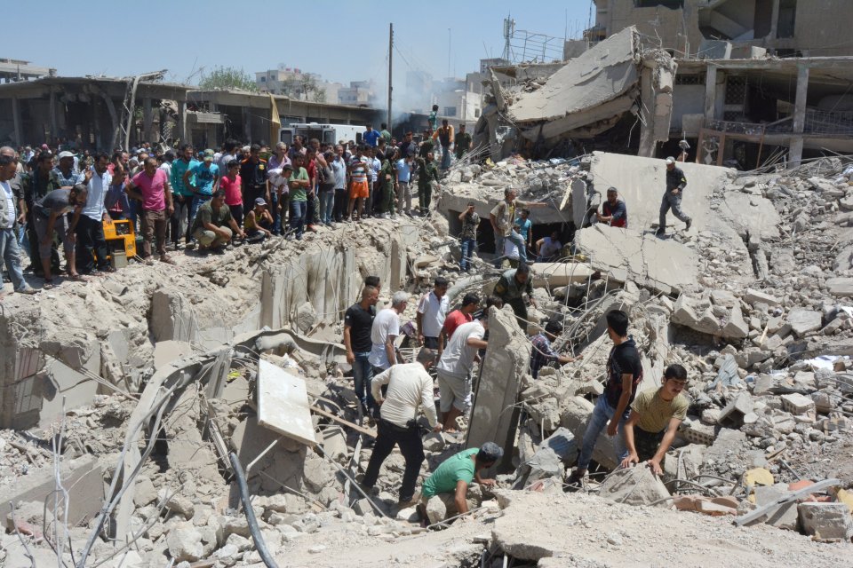 People look for survivors from under debris at a damaged site 