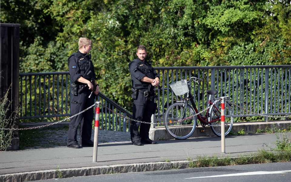 Plicemen officers stand outside a migran