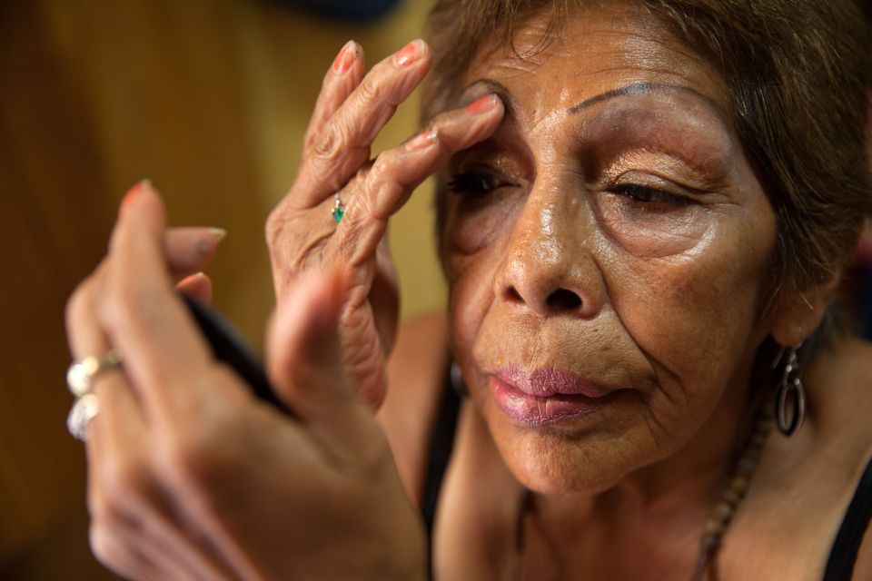 Luchita is one of those who use the shelter in Mexico's capital. Here she applies make up in her bedroom