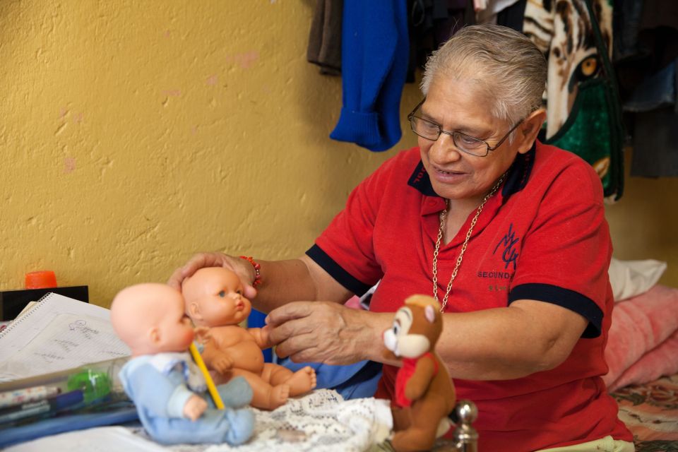 Elia, another resident at the shelter, is pictured here taking care of her dolls at the home