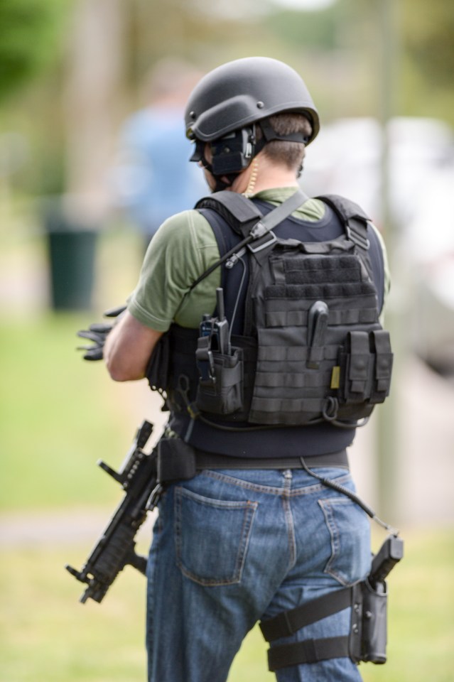 Eye witnesses say that an armed man is refusing to come out of his house following a suspected botched drug raid