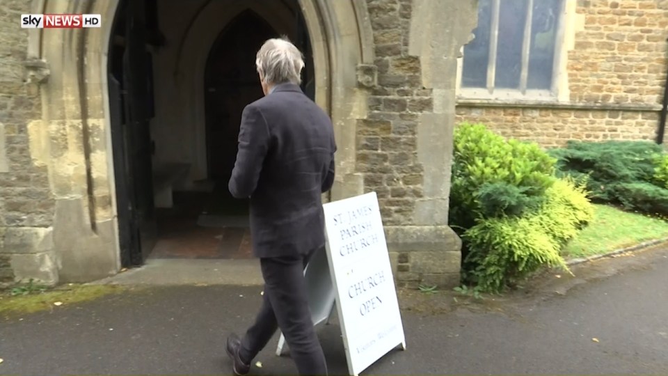 In the clip he walks into the church after reading out a sign which says "everybody is welcome"