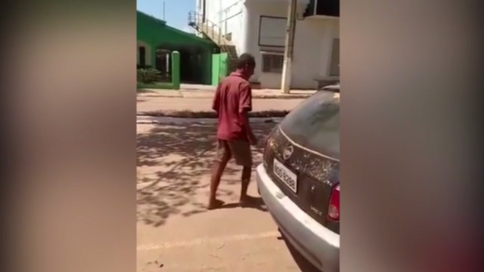 The man then sheepishly makes his way down the street after he realises he has been caught