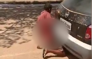 Bizarre moment extreme car lover is caught having sex with a hatchback's exhaust pipe