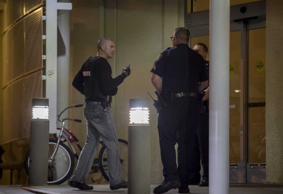 Police officers gather at the emergency entrance to UCSD Medical Center Hillcrest 