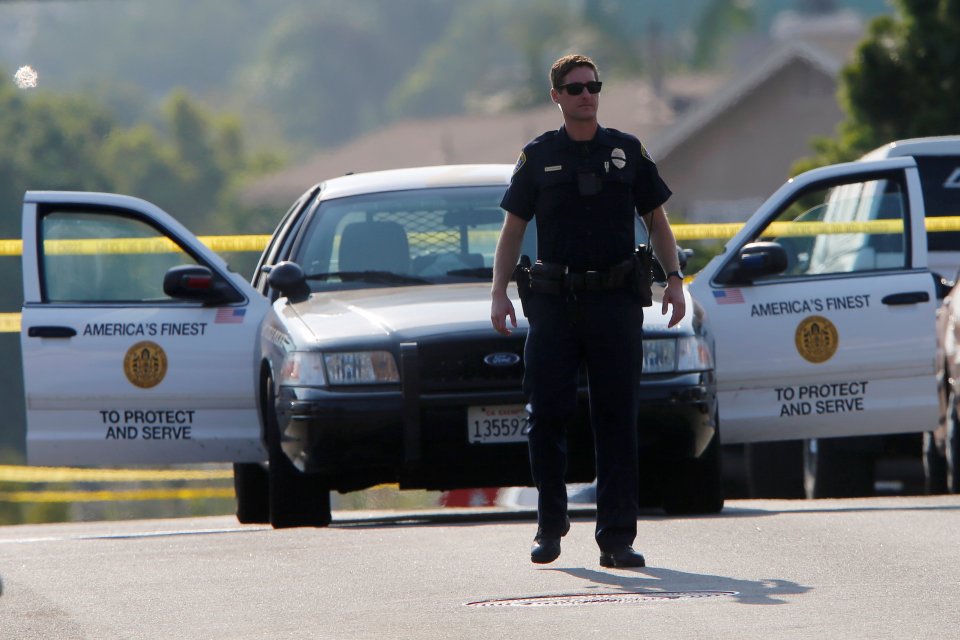 Police block off roads as they protect a crime scene after a San Diego police officer was fatally shot