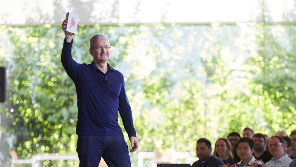Apple CEO Tim Cook holds his iPhone in the air... it's not known whether he waved it around like he just doesn't care