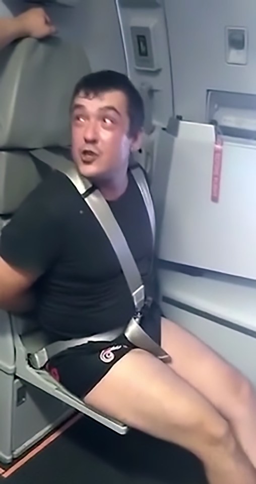 Pic shows: Maxim G strapped to the seat; This is the shocking moment that a drunken air passenger was bound and strapped to a seat after punching a flight attendant in the face. It happened on an Aeroflot flight from the city of Yuzhno-Sakhalinsk, on the island of Sakhalinsk off Russia's eastern coast, to the capital city of Moscow. The captain tried to convince the passenger, named as Maxim G, to calm down and return to his seat after flight attendants complained about his behaviour. But, instead, Maxim G lost his temper and punched one of the stewards in the face. Other passengers rushed to help the cabin crew restrain him before binding his wrists behind his back with duct tape from the galley. They then strapped him into a flight attendant's seat to keep him away from other passengers. The incident was filmed by another passenger with a smartphone who uploaded the footage to social media where it quickly went viral. In the clip, Maxim G can be heard still swearing at the cabin crew and challenging them to a fight - despite his predicament. He says: "Come on, punch me, come on. You can do it, can't you? Punch me f***ing hard!" The video attracted lots of posts by online commentators including netizen 'Sergey Vasiliev' who summed up the feelings of the majority when he said: "Go punch him if he wants it so much!" The plane was met on the runway by police officers who took Maxim G into custody. He faces charges and a possible jail sentence. Aeroflot, officially titled Aeroflot – Russian Airlines, is the Russian Federation's largest and best known airline.