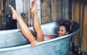 Caroline Flack posts racy bath photograph as she ignores tonight's new series of The X Factor