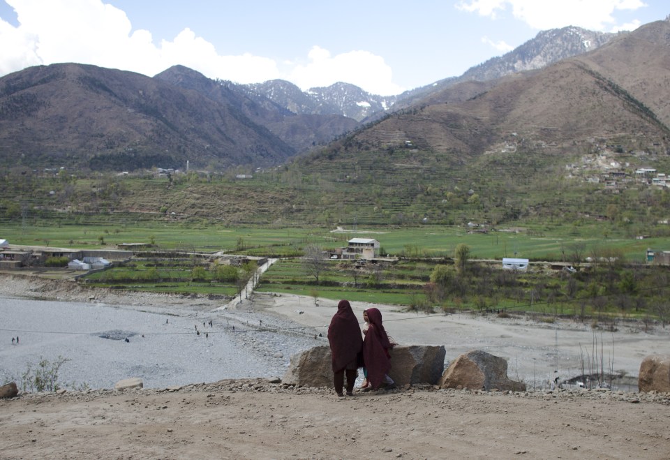 Young girls in headscarves look out over Swat Valley, where a man and woman were stoned (stock image)