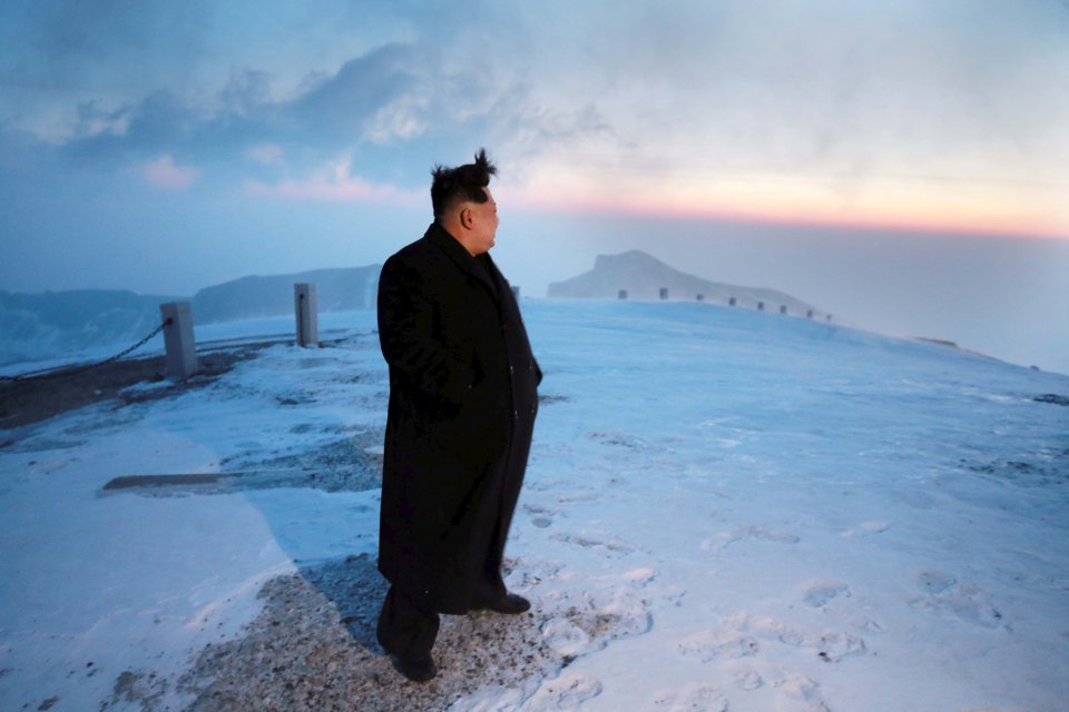 North Korean leader Kim Jong Un views the dawn from the summit of Mt Paektu with warnings his nuclear tests could be making the volcano more likely to erupt