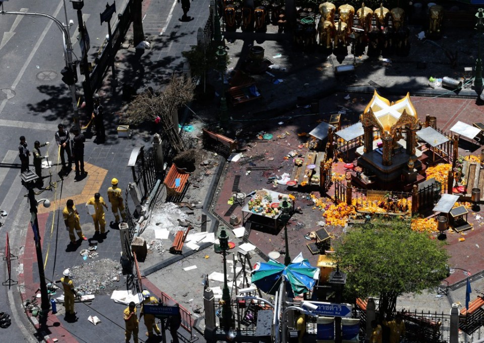 Thai police officers and emergency staff inspect the scene where a bomb was detonated on 17 August outside Erawan Shrine with fears the same culprits were behind the most recent hombings