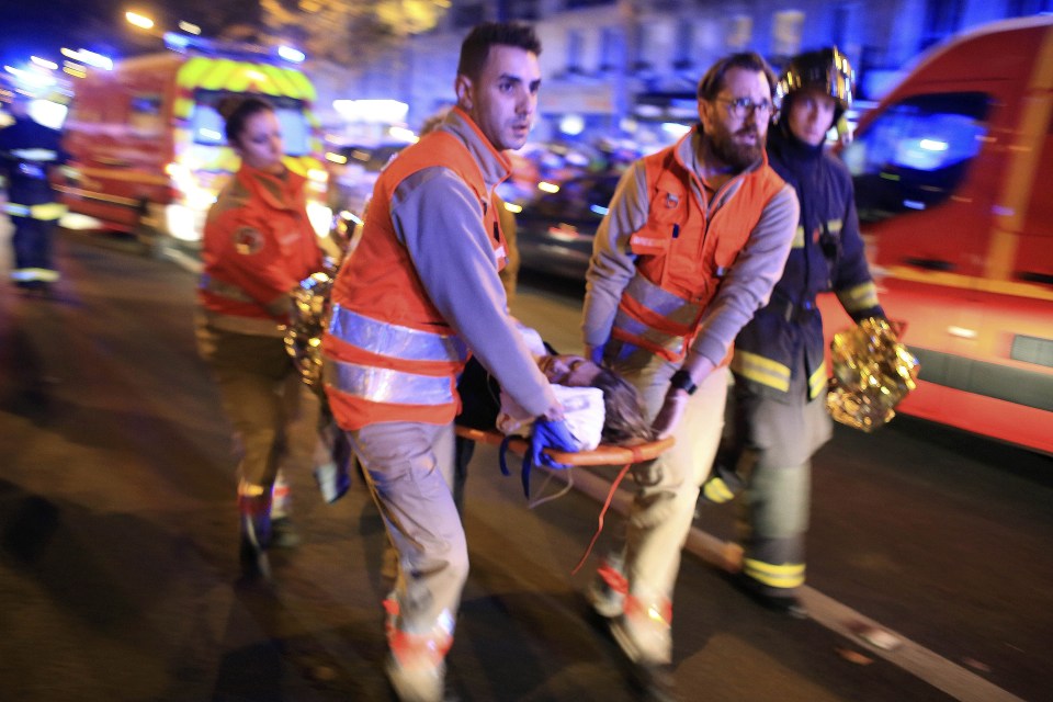 Medics rush an injured woman out of the Bataclan