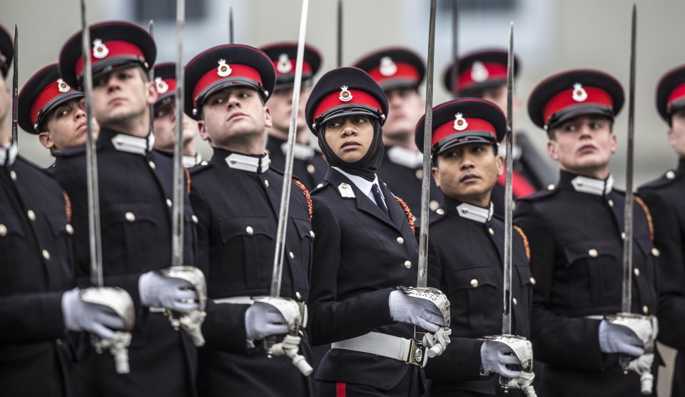 A graduating female officer cadet wears traditional muslim headress as she marches on parade at sandhurst military academy during the Sovereign's parade.