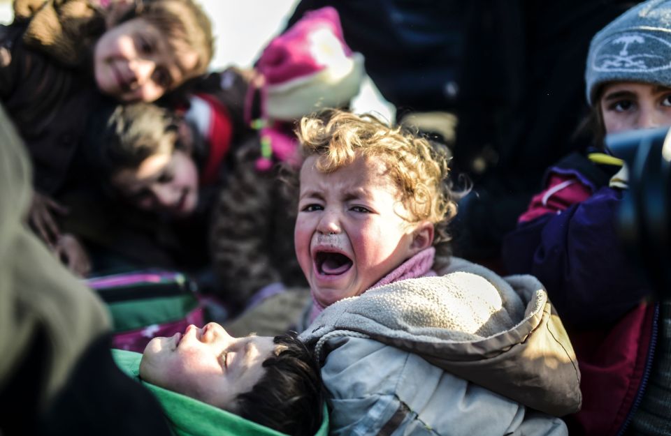 A Syrian child cries as Syrians fleeing