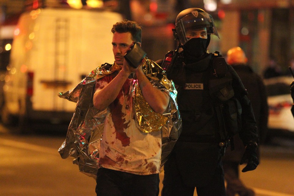 One of the injured victim escorted by the police in front Bataclan concert hall after the terror attack last year