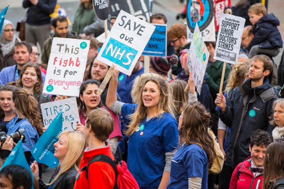 Junior doctors striking outside hospitals about the new NHS contract