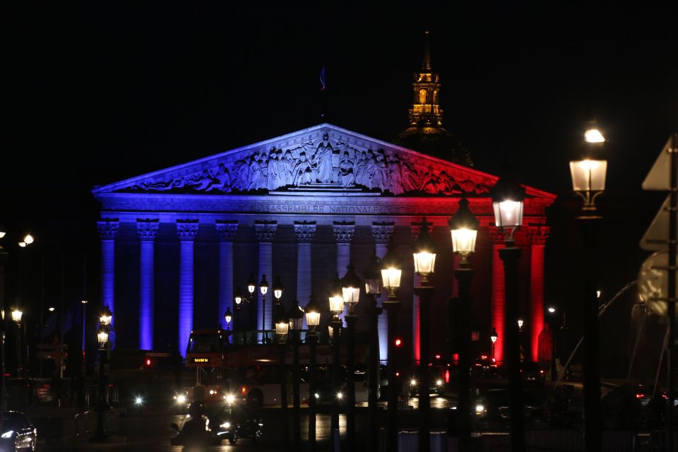 The National Assembly's palais Bourbon in Paris illuminated in the French flag colours in tribute to the victims of the attack in the Normandy city of Saint-Etienne-du-Rouvray