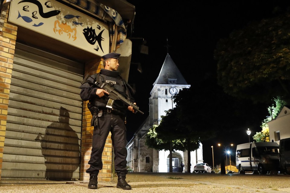 French riot police guards the street to access the church where an hostage taking left a priest dead in Saint-Etienne-du-Rouvray, Normandy