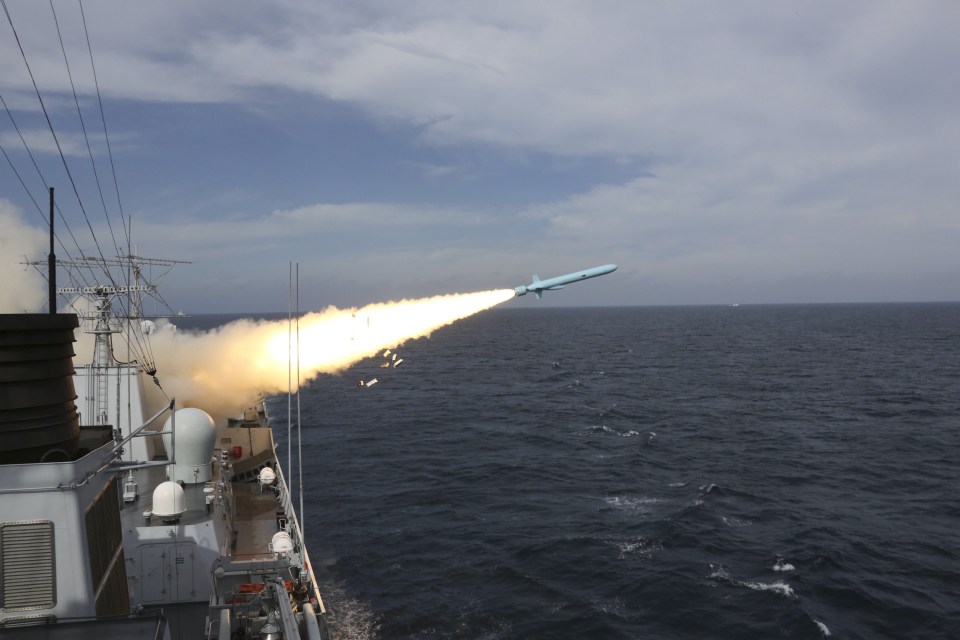 A missile is launched from a guided-missile destroyer during a live ammunition drill in the East China Sea