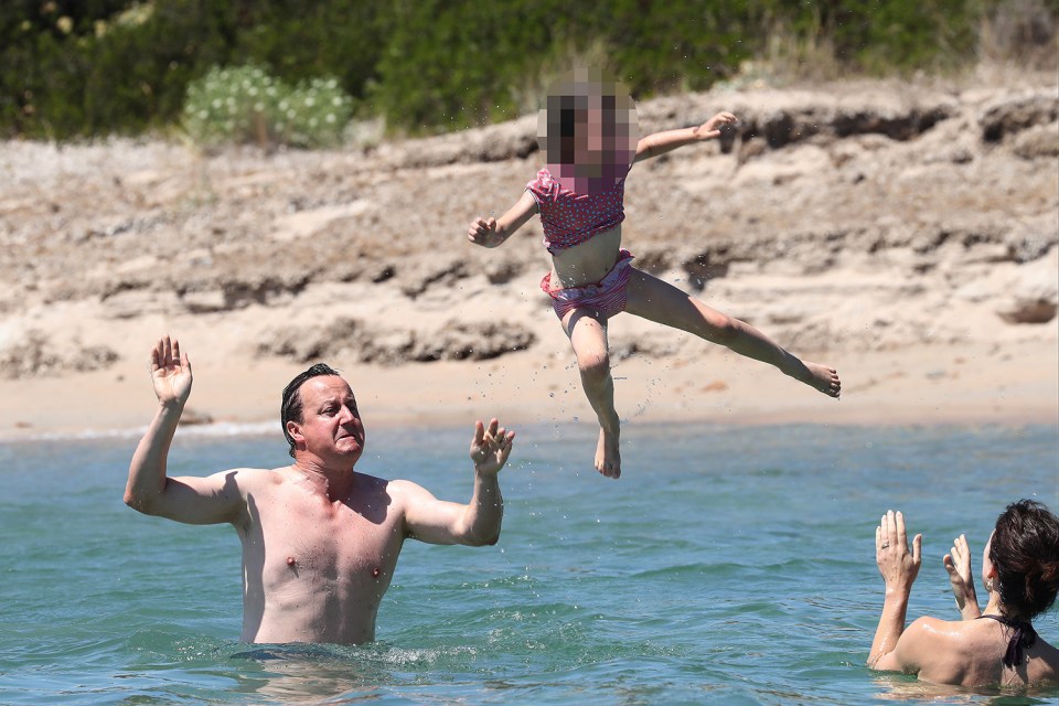 Higher! . . . Cameron messes around in the sea after tough Brexit battle