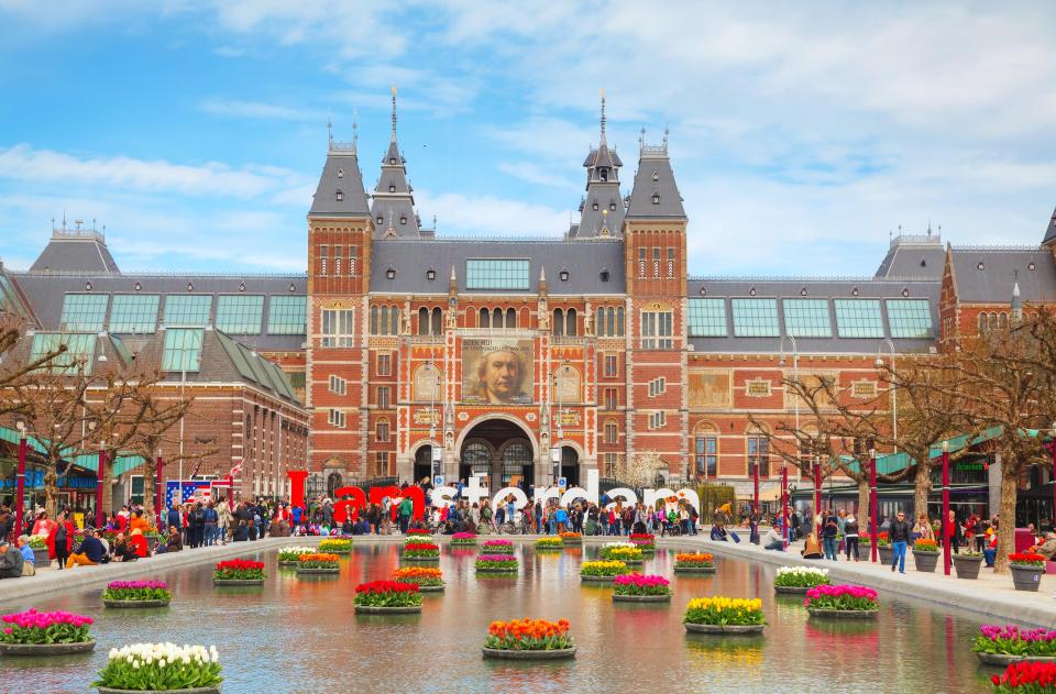 AMSTERDAM - APRIL 16: I Amsterdam slogan with crowd of tourists on April 16, 2015 in Amsterdam.