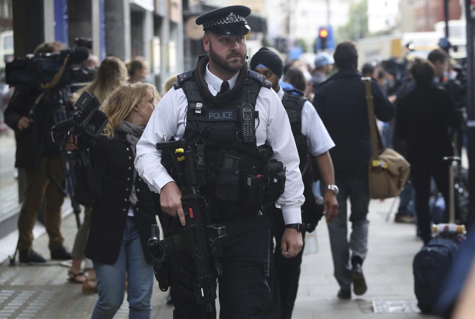 Armed police officers patrol at the scene of a knife attack in Russell Square in London